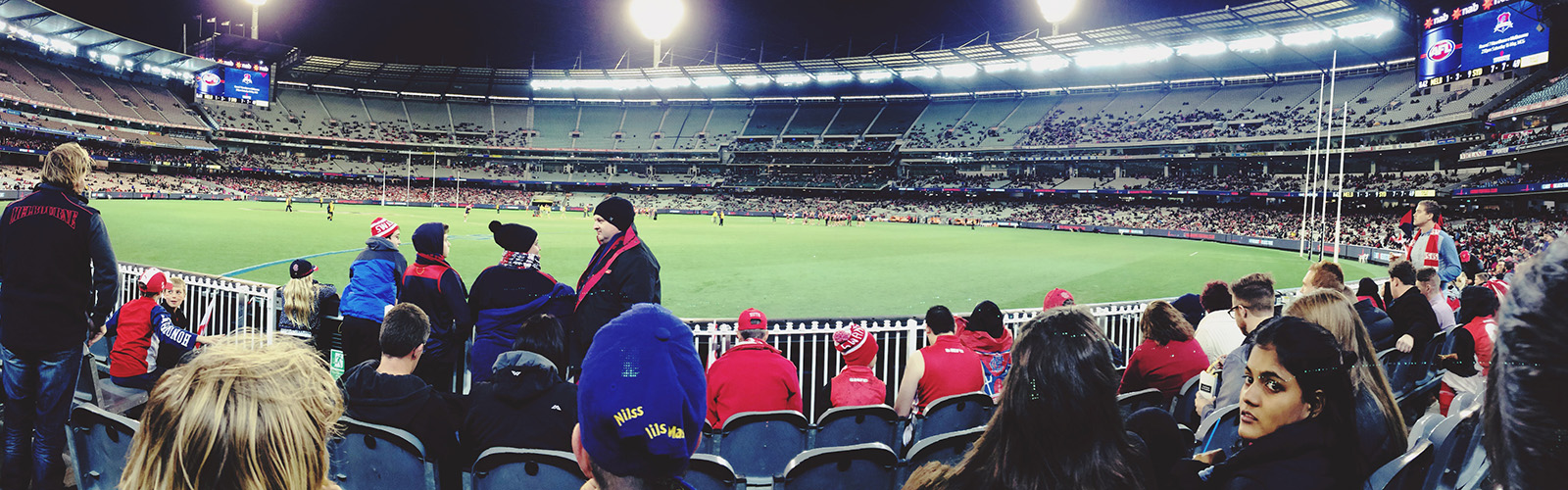 Fans are filling in seats at a sporting event.